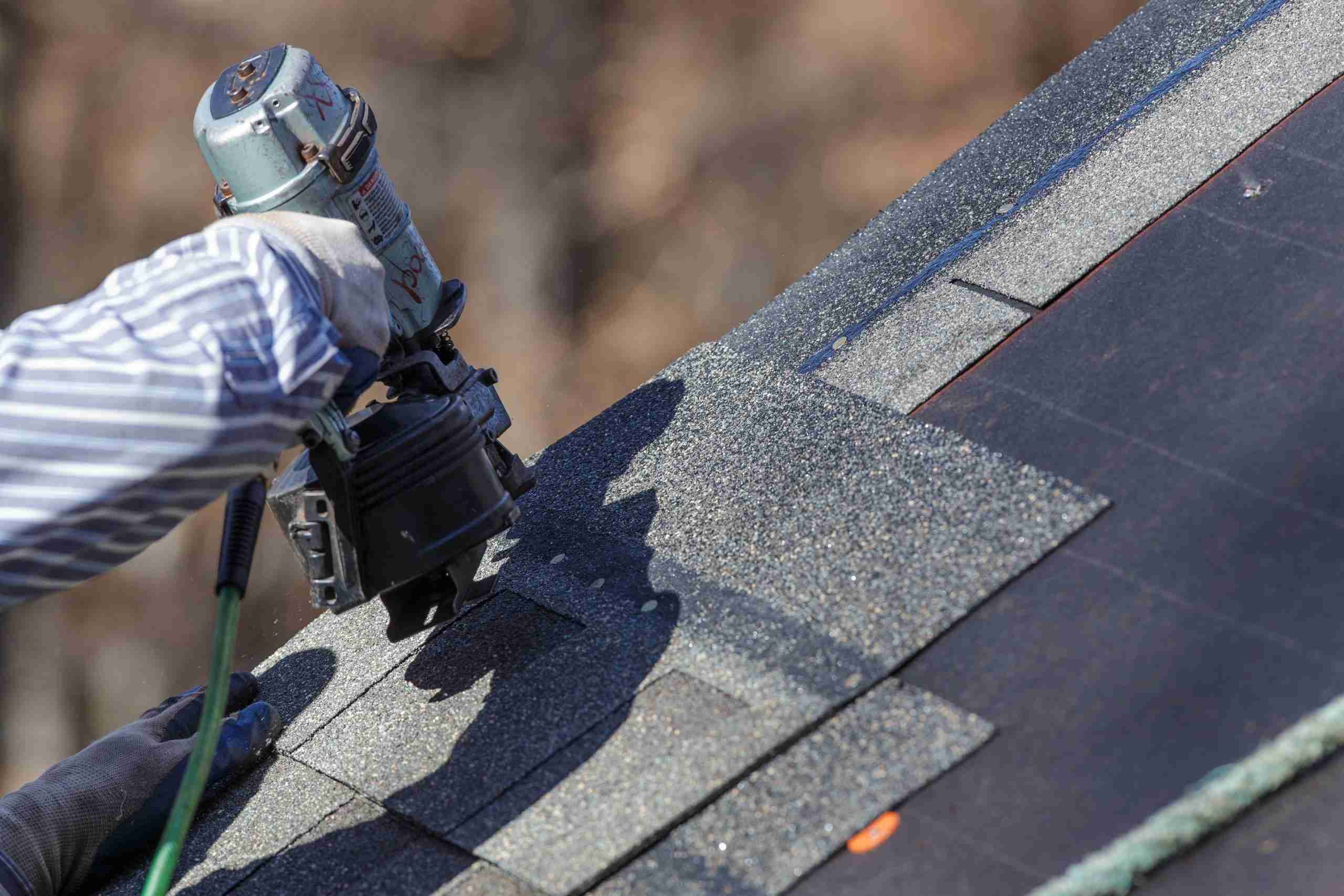 Roofing professionals installing asphalt shingles