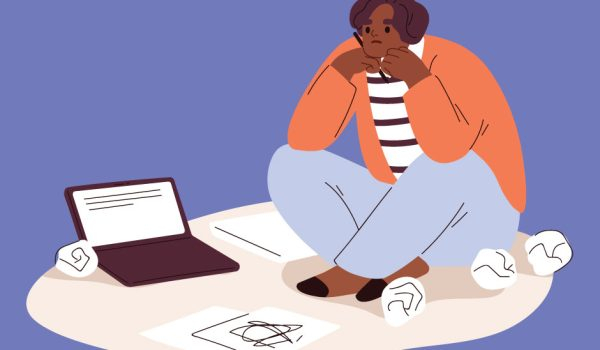 Woman in deep though in front of her laptop